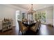 Spacious dining room with a large window, seating for eight, and a wet bar at 4115 Falls Ridge Dr, Johns Creek, GA 30022