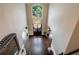 Elegant foyer boasts a stunning chandelier, soaring ceilings, and gleaming hardwood floors at 4115 Falls Ridge Dr, Johns Creek, GA 30022