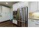 Modern kitchen with stainless steel appliances, granite countertops, and custom cabinets at 4115 Falls Ridge Dr, Johns Creek, GA 30022