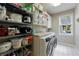 Laundry room with modern appliances, wire shelving and a view of the outdoors at 4115 Falls Ridge Dr, Johns Creek, GA 30022