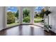 Bright living room featuring beautiful arched windows offering great natural light and views of the landscaped yard at 4115 Falls Ridge Dr, Johns Creek, GA 30022