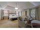 Bright and airy main bedroom offering a sitting area, tray ceiling, and neutral decor at 4115 Falls Ridge Dr, Johns Creek, GA 30022