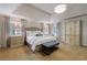 Spacious main bedroom featuring a tray ceiling, plush carpet, and lots of natural light at 4115 Falls Ridge Dr, Johns Creek, GA 30022