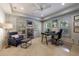 Bright office space featuring built-in shelving, a ceiling fan, and two windows with natural light at 4115 Falls Ridge Dr, Johns Creek, GA 30022