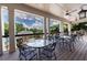 Covered patio with tables and chairs offering a relaxing outdoor space overlooking green landscape at 4115 Falls Ridge Dr, Johns Creek, GA 30022