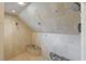 Shower features light natural tile, two shower heads, and granite corner seating at 4115 Falls Ridge Dr, Johns Creek, GA 30022