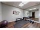 Basement workout room with weights, bench, exercise ball, and mirrored wall at 4115 Falls Ridge Dr, Johns Creek, GA 30022