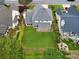 An aerial view of the rear of a home with a manicured lawn, landscaping, and outdoor living space at 4206 Moccasin Trl, Woodstock, GA 30189