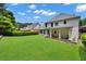 Spacious backyard featuring a well-manicured lawn, covered patio, and lush landscaping at 4206 Moccasin Trl, Woodstock, GA 30189
