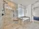 Bright bathroom features a glass enclosed walk-in shower, soaking tub, tile surround, and private water closet at 4206 Moccasin Trl, Woodstock, GA 30189