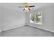 Empty room with large window, ceiling fan, and plush carpeting at 4206 Moccasin Trl, Woodstock, GA 30189