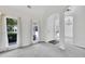 Spacious, empty room highlighting neutral carpet, natural light, and access to the dining area at 4206 Moccasin Trl, Woodstock, GA 30189