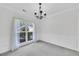 Bright and airy empty dining room showing wainscoting, a chandelier, and natural light at 4206 Moccasin Trl, Woodstock, GA 30189