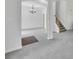Open room showing a stairway, with neutral carpet, an elegant light fixture, and neutral decor at 4206 Moccasin Trl, Woodstock, GA 30189