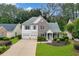 Charming two-story home with a two-car garage, stone accents, and a well-manicured lawn at 4206 Moccasin Trl, Woodstock, GA 30189