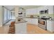 Open kitchen with island, granite countertops, stainless appliances, and access to Gathering room at 4206 Moccasin Trl, Woodstock, GA 30189