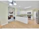 Open floorplan featuring kitchen with white cabinets and stainless appliances at 4206 Moccasin Trl, Woodstock, GA 30189