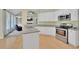 Open kitchen with island, granite countertops, stainless appliances, and access to Gathering room at 4206 Moccasin Trl, Woodstock, GA 30189