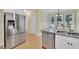 Bright kitchen features stainless steel appliances, light countertops, hardwood floors and a window bringing in light at 4206 Moccasin Trl, Woodstock, GA 30189