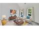 Bright living room with vaulted ceilings, neutral decor, and natural light from large windows at 4206 Moccasin Trl, Woodstock, GA 30189