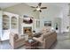 Staged living room with fireplace, built-in shelving, vaulted ceiling, and neutral furniture at 4206 Moccasin Trl, Woodstock, GA 30189