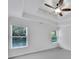 Spacious bedroom features tray ceilings, a ceiling fan, neutral walls, and large windows for natural light at 4206 Moccasin Trl, Woodstock, GA 30189