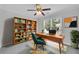 Bright home office featuring a wooden desk, ceiling fan, and plenty of natural light at 4206 Moccasin Trl, Woodstock, GA 30189