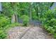 Stone patio area with wooden fence provides a private backyard space at 7025 Stone Wood Nw Dr, Kennesaw, GA 30152