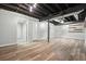Spacious finished basement with laminate floors and exposed ceiling beams at 7025 Stone Wood Nw Dr, Kennesaw, GA 30152