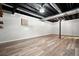 Spacious finished basement with laminate floors and exposed ceiling at 7025 Stone Wood Nw Dr, Kennesaw, GA 30152