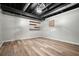 Finished basement features wood-look flooring, utility boxes and an exposed ceiling at 7025 Stone Wood Nw Dr, Kennesaw, GA 30152