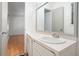Bright bathroom features a large mirror and vanity with white cabinets and modern fixtures at 7025 Stone Wood Nw Dr, Kennesaw, GA 30152