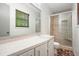 Bathroom featuring a walk-in shower and a window above the counter at 7025 Stone Wood Nw Dr, Kennesaw, GA 30152