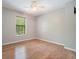 Bedroom featuring hardwood floors, a garden view window, and ample natural light at 7025 Stone Wood Nw Dr, Kennesaw, GA 30152