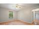 Bedroom featuring hardwood floors, closet, and a window with trees outside at 7025 Stone Wood Nw Dr, Kennesaw, GA 30152