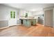 Spacious kitchen with an island, stainless steel appliances, hardwood floors, and garden view windows at 7025 Stone Wood Nw Dr, Kennesaw, GA 30152