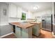 Charming kitchen featuring a moveable island, stainless steel refrigerator, hardwood floors, and a garden view at 7025 Stone Wood Nw Dr, Kennesaw, GA 30152