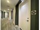 Well-lit hallway with gray wood flooring, white doors and modern design at 788 W Marietta Nw St # 512, Atlanta, GA 30318