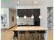 Modern kitchen island with stainless steel appliances, ample seating, and pendant lighting at 788 W Marietta Nw St # 512, Atlanta, GA 30318