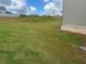 Side view of the backyard that offers a wide green yard with plenty of room to roam at 118 Longhorn Way, Auburn, GA 30011