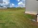 The side of the house shows a big grass backyard and the side of the gray siding at 118 Longhorn Way, Auburn, GA 30011