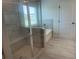 Modern bathroom featuring a glass-enclosed shower, soaking tub, and tiled walls at 118 Longhorn Way, Auburn, GA 30011