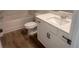 Cozy bathroom with a single vanity, bathtub, and wood-look tile flooring at 118 Longhorn Way, Auburn, GA 30011