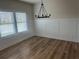 Bright and airy dining room featuring hardwood floors, a modern chandelier, and wainscoting at 118 Longhorn Way, Auburn, GA 30011