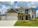 Charming two-story brick home with a two-car garage and a manicured front yard at 118 Longhorn Way, Auburn, GA 30011