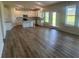 Open-concept kitchen featuring white cabinets, granite countertops, and stainless steel appliances at 118 Longhorn Way, Auburn, GA 30011