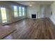 Spacious living room with a fireplace, large windows, and hardwood floors throughout at 118 Longhorn Way, Auburn, GA 30011