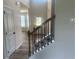 Elegant staircase with hardwood floors and black metal railings leading to the upper level at 118 Longhorn Way, Auburn, GA 30011