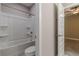 Bathroom with tiled shower and toilet area next to entry to bedroom at 150 Whitworth Dr, Locust Grove, GA 30248