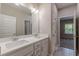 Bathroom features double vanity and a view to bedroom and hall at 150 Whitworth Dr, Locust Grove, GA 30248